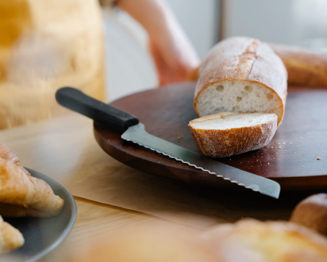 Serrated bread knife next to a loaf